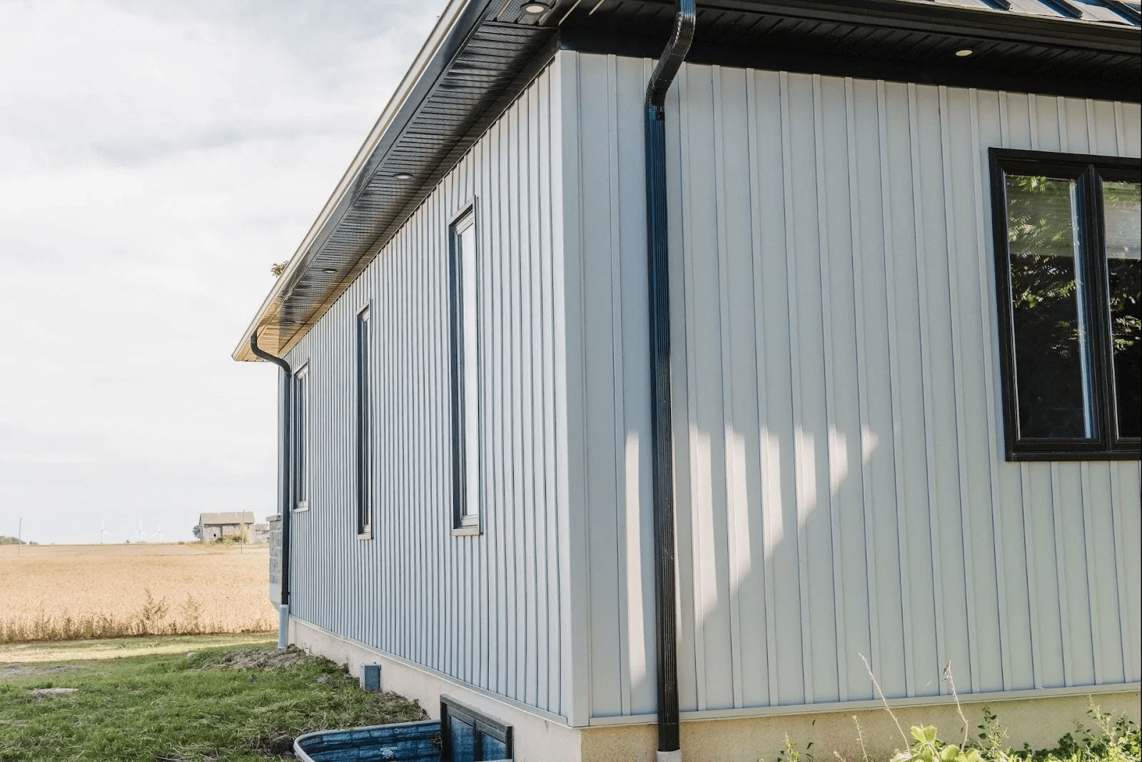 A residential building with a light-coloured steel siding.