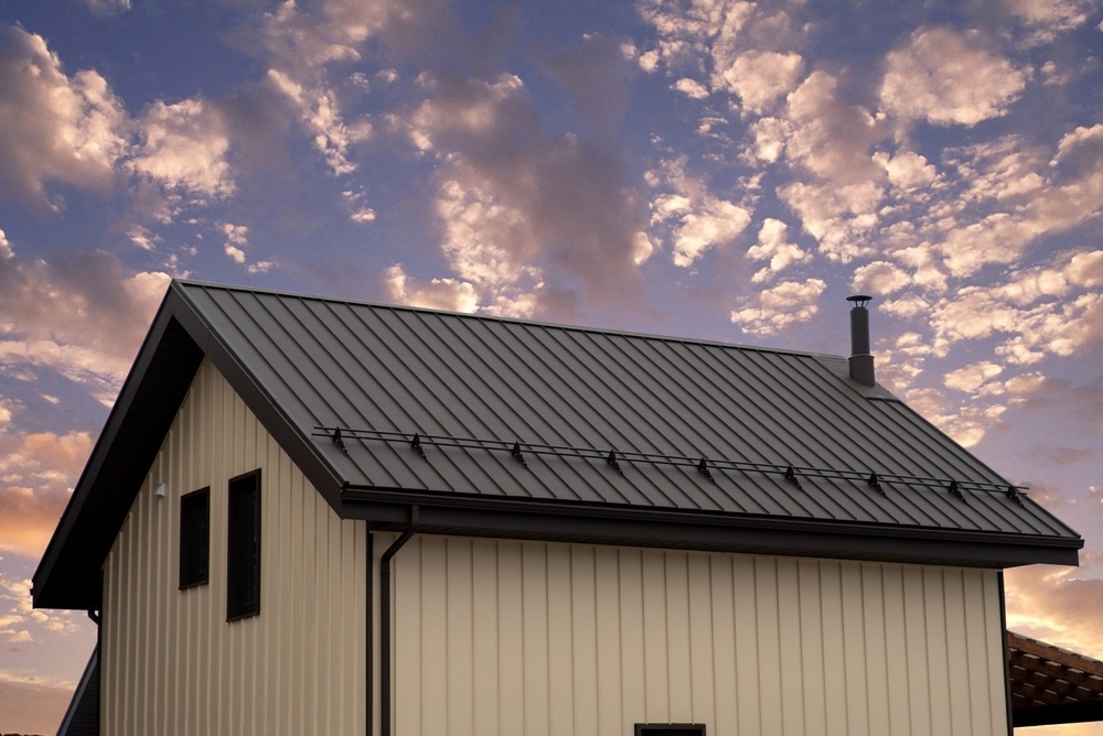 A small house with a metal roof that has been repaired to stop leaks.