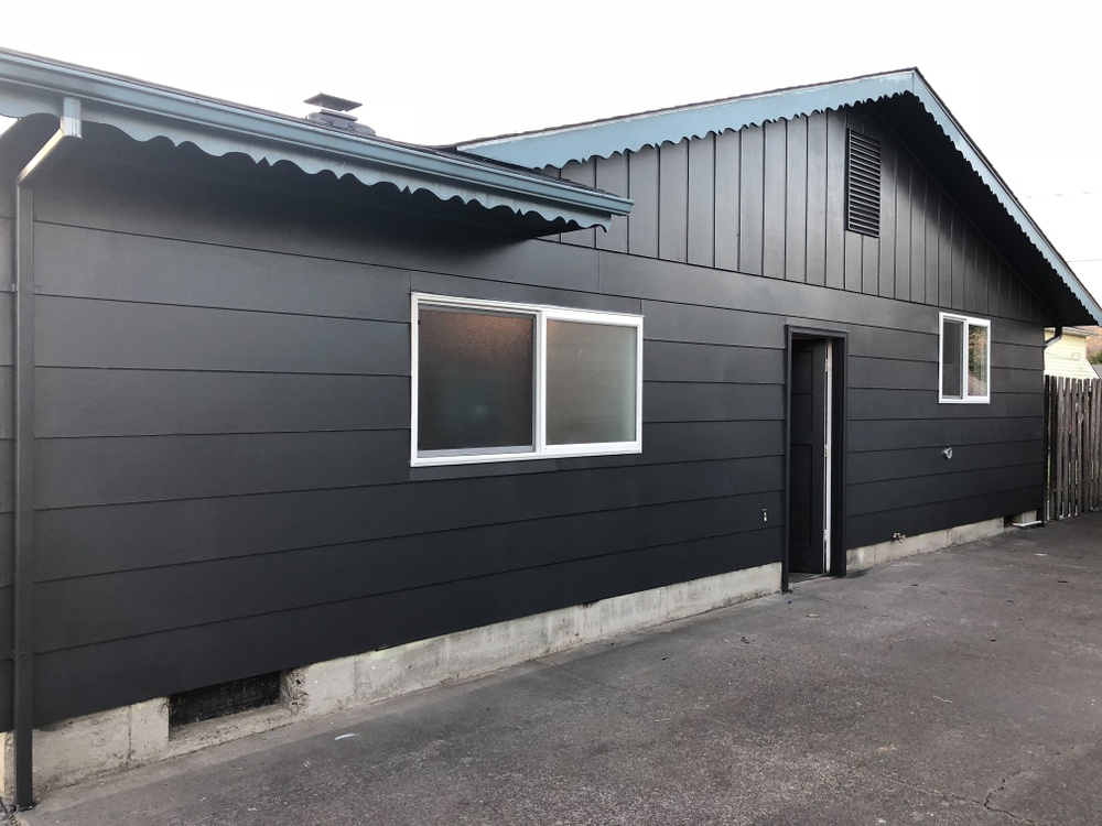 A house with metal siding painted black.